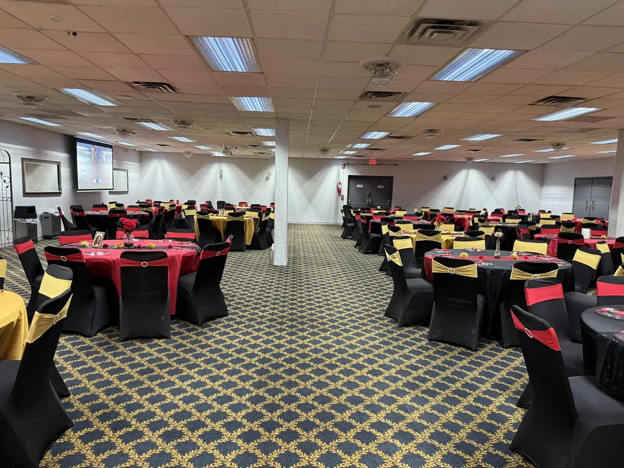 Round banquet tables set up with decorations for a birthday or graduation party